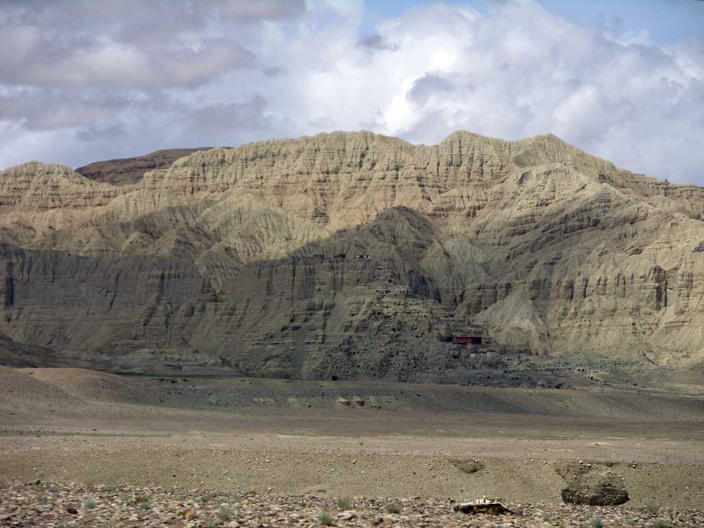 Tibet Guge 05 Tsaparang 01 Long View While emerging from a gorge and turning the spur of a mountain -  we suddenly beheld the lofty castles of the ancient city of Tsaparang, which seemed to be carved out of the solid rock of an isolated, monolithic mountain peak, we gasped with wonder and could hardly believe our eyes. - Lama Anagarika Govinda: The Way of the White Clouds.